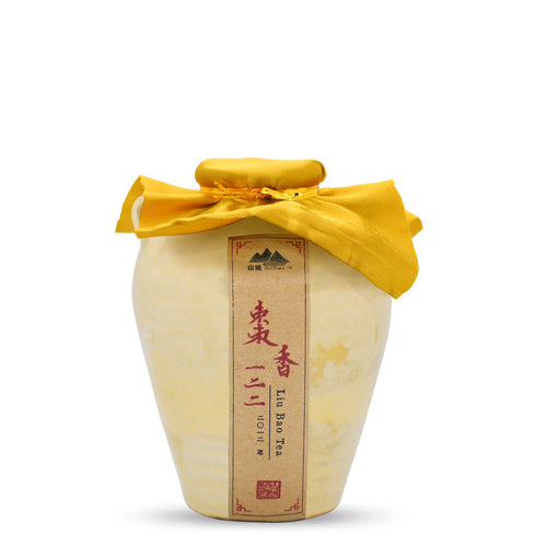 a close up of a ceramic pot of aged liu bao tea