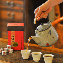 Load image into Gallery viewer, a vintage chinese tea place and a man holding a large teapot to pouring out ripe puerh tea
