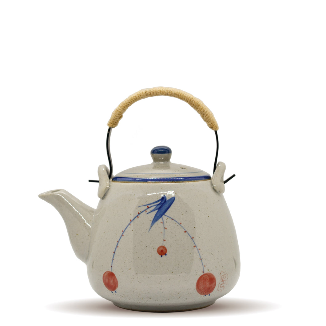 a close up of a hand-painted ceramic teapot