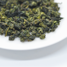 Load image into Gallery viewer, a close up of a oolong tea leaves
