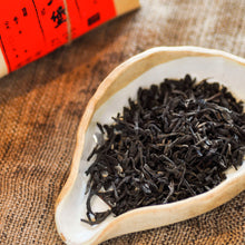 Load image into Gallery viewer, a ceramic tea receptacle filled with liu bao tea on vintage cloth
